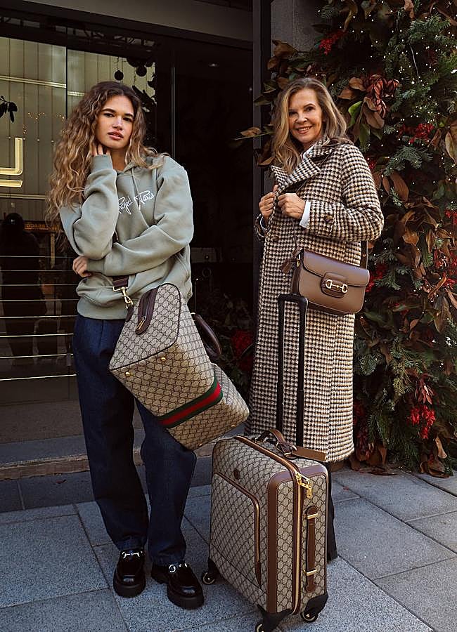 Imagen - Mari Luz lleva abrigo de tejido italiano de Maksu, pantalones de Gucci, camisa blanca de Gucci, bolso de hombre de Gucci Horsebit 1955, maleta de mano de Gucci Valigeria. Natalia lleva sudadera con capucha unisex de Essentials Project X Paris, pantalón de pinzas de Dockers, mocasines de Gucci y bolsa de viaje de Gucci Valigeria. Foto: Javier Pérez Pla