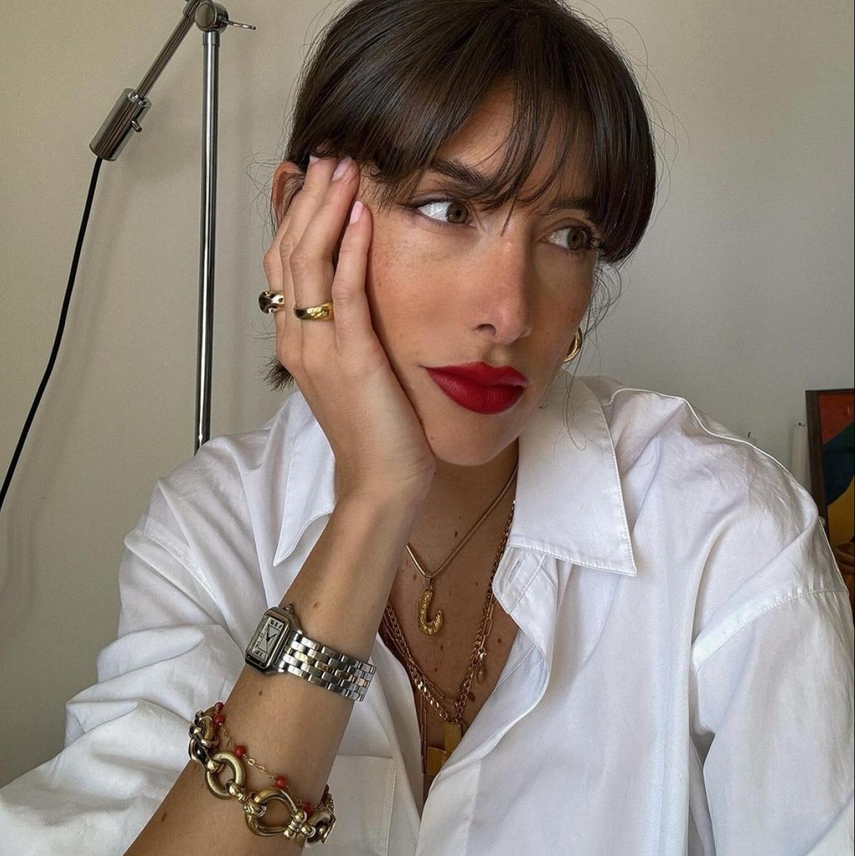 Un influencer con un reloj plateado.