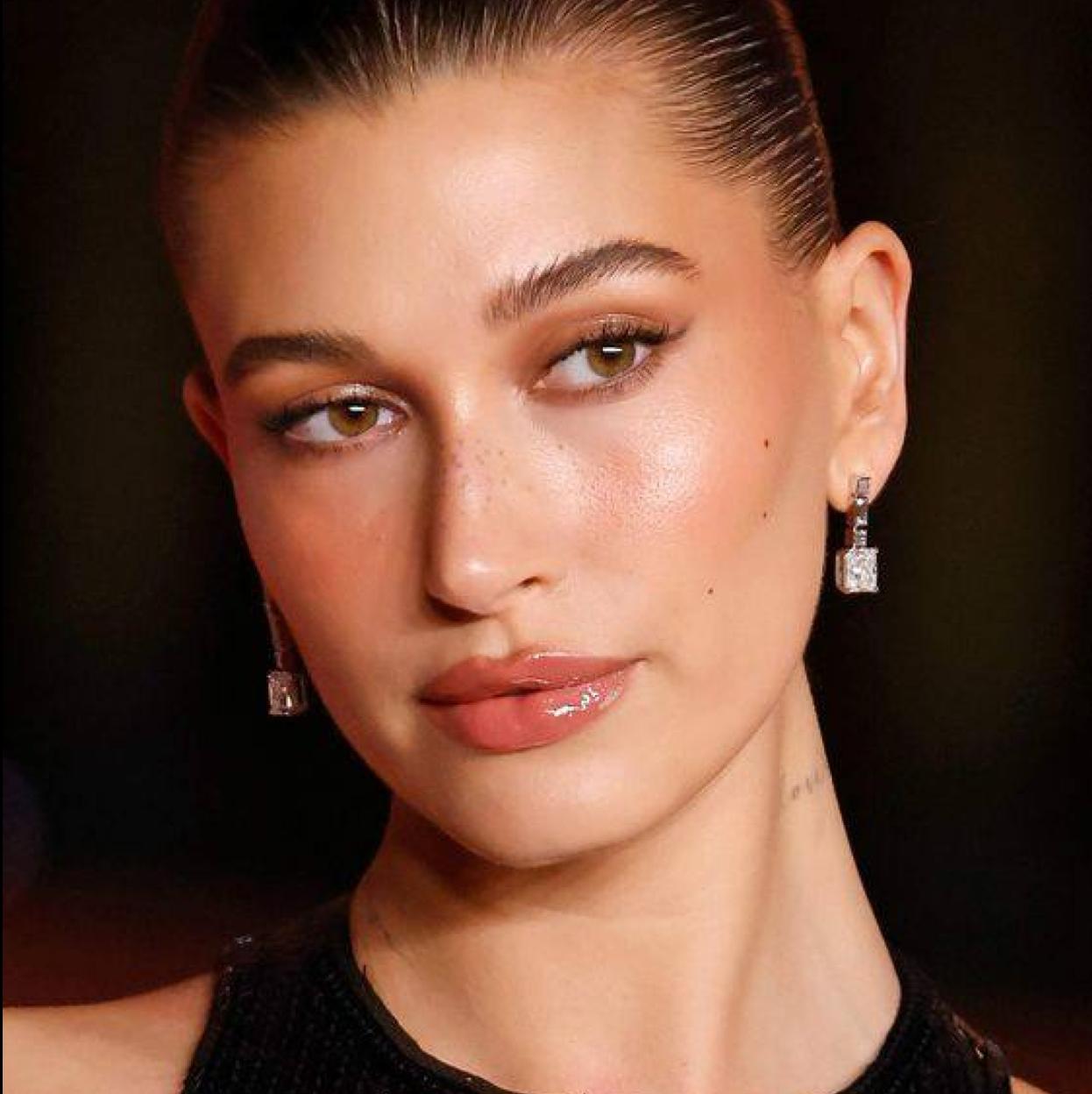 Hailey Bieber con aceite labial brillante