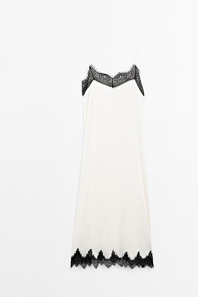 Es un vestido blanco con encaje negro.
