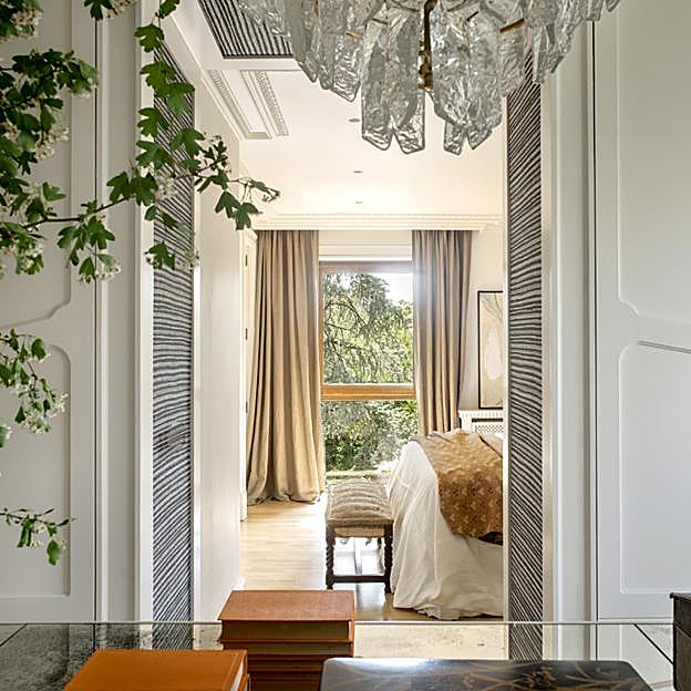 El dormitorio principal desde el vestidor, con lámpara de cristal de Murano.