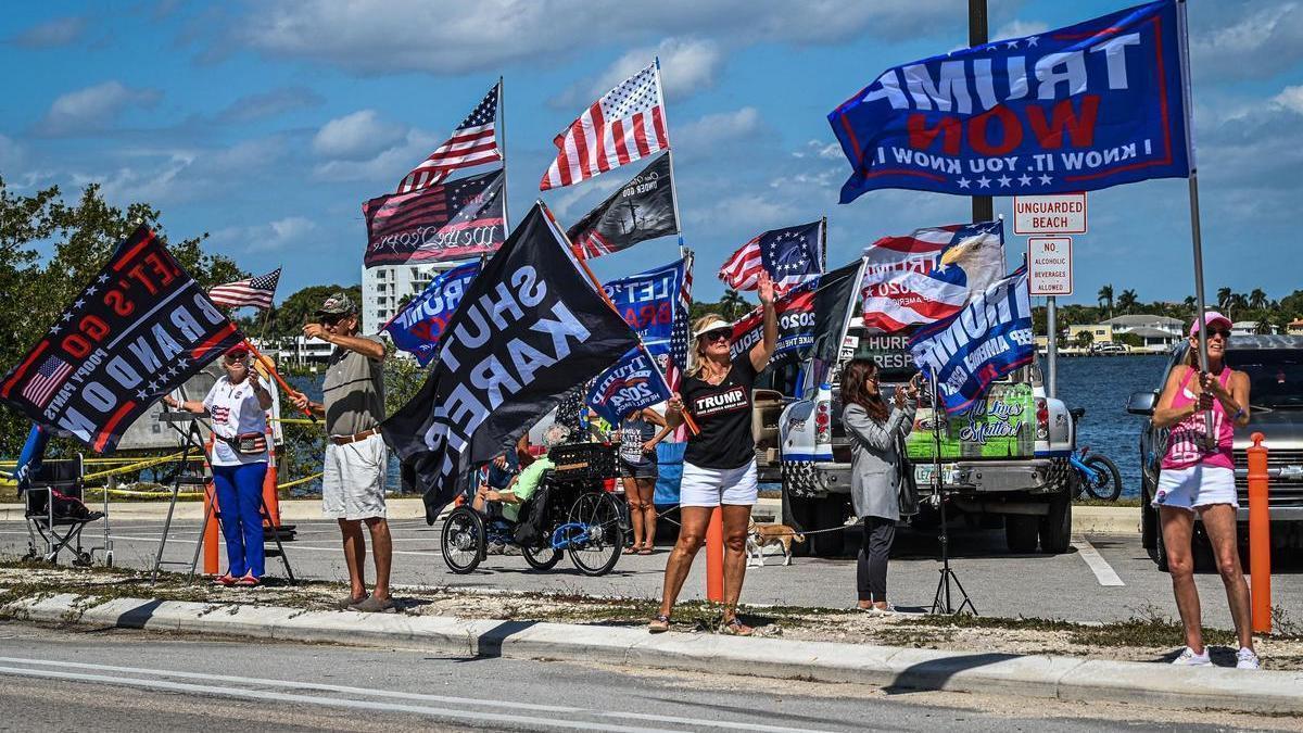 The only real image in this report, that of dozens of supporters cheering Trump on at Mar-a-Lago after learning of his possible arrest
