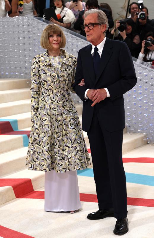 Anna Wintour, anfitriona de la gala, con un abrigo de la última colección de alta costura de Chanel, primavera verano 2023, diseñada por Virginie Viard. Posa junto a su pareja, el actor Bill Nighy. 