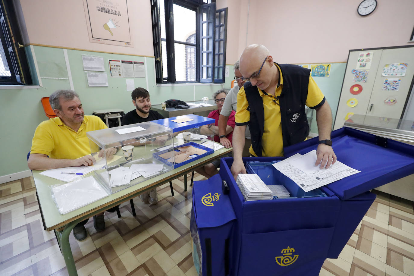 Un cartero entrega votos en un colegio electoral de Zaragoza.