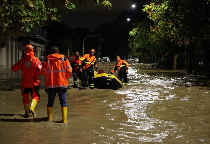 Miembros de un equipo de rescate en una calle anegada de agua en la Toscana.