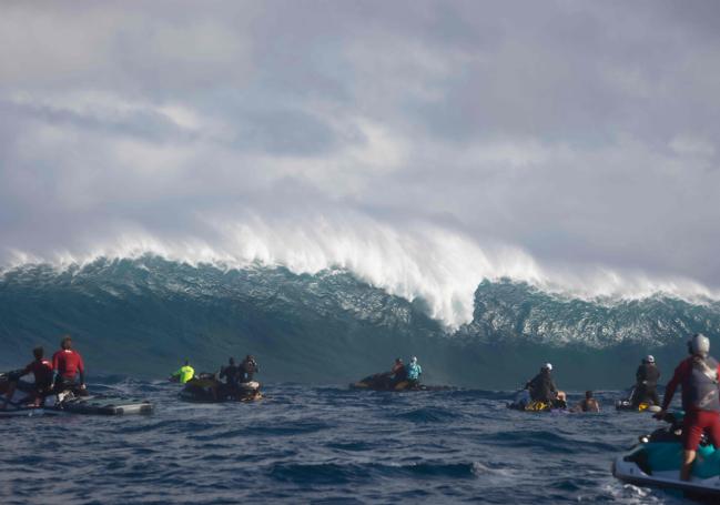 Varios personas en motos de agua esperan las olas durante un gran oleaje en el norte de Maui