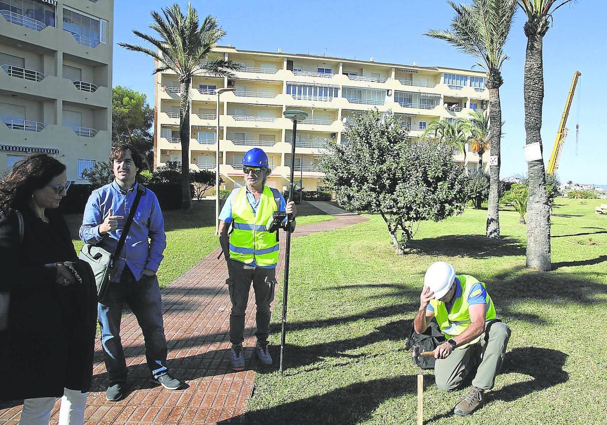 Los topógrafos señalan en el jardín de una urbanización de Dénia el límite del dominio público.