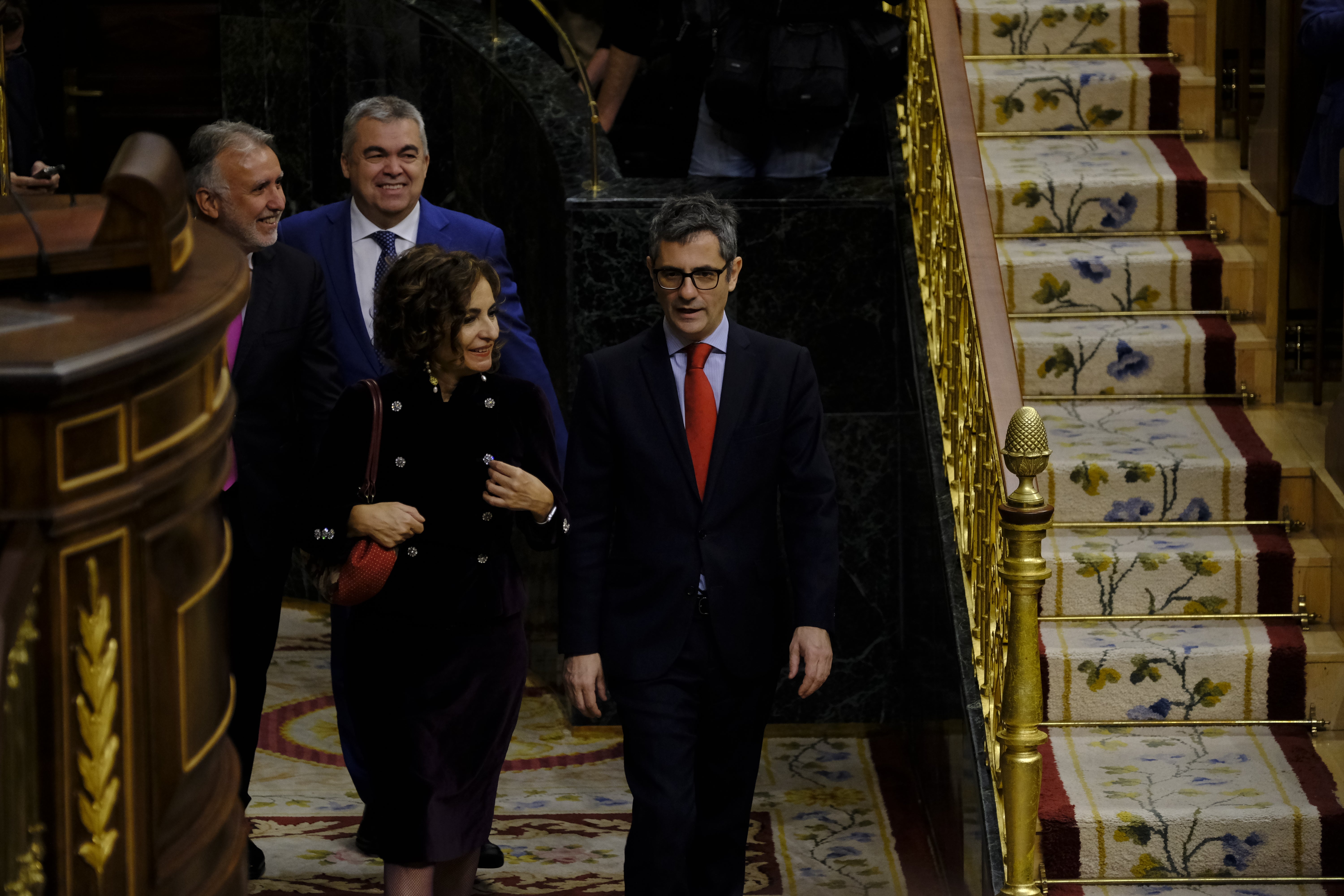 María Jesús Montero y Félix Bolaños entran para ocupar sus sillones. Detras, Santos Cerdán, quien cerró el pacto entre el PSOE y Junts.