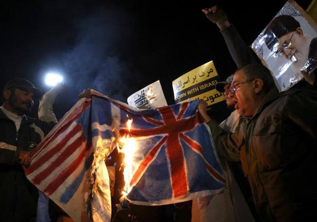 Quema de banderas de EE UU y Reino Unido como protesta por los ataques.