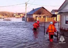 Un grupo de rescatistas camina por una calle inundada de la ciudad de Orsk, en la región de los Urales.