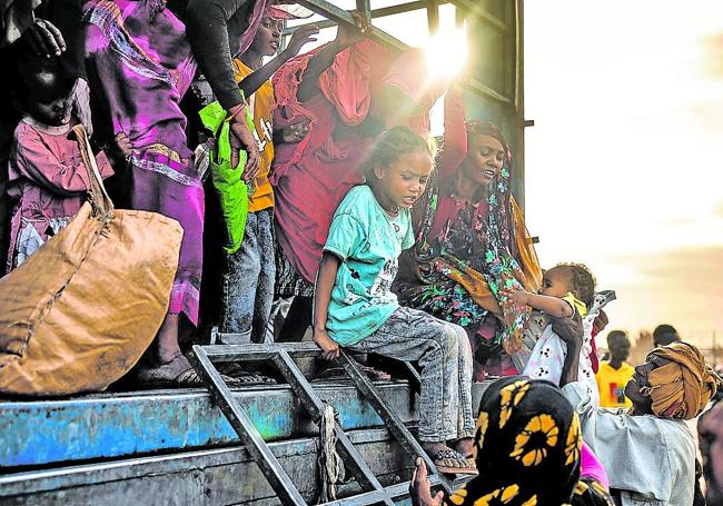 Familias sudanesas a su llegada a un centro de tránsito para refugiados en Renk.