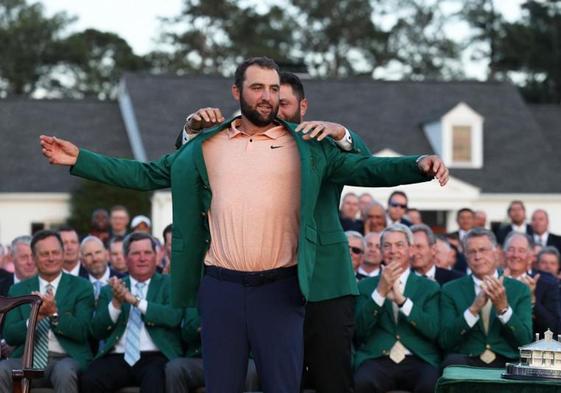 Scheffler recibe la chaqueta verde de Rahm, como ganador del Masters de Augusta.