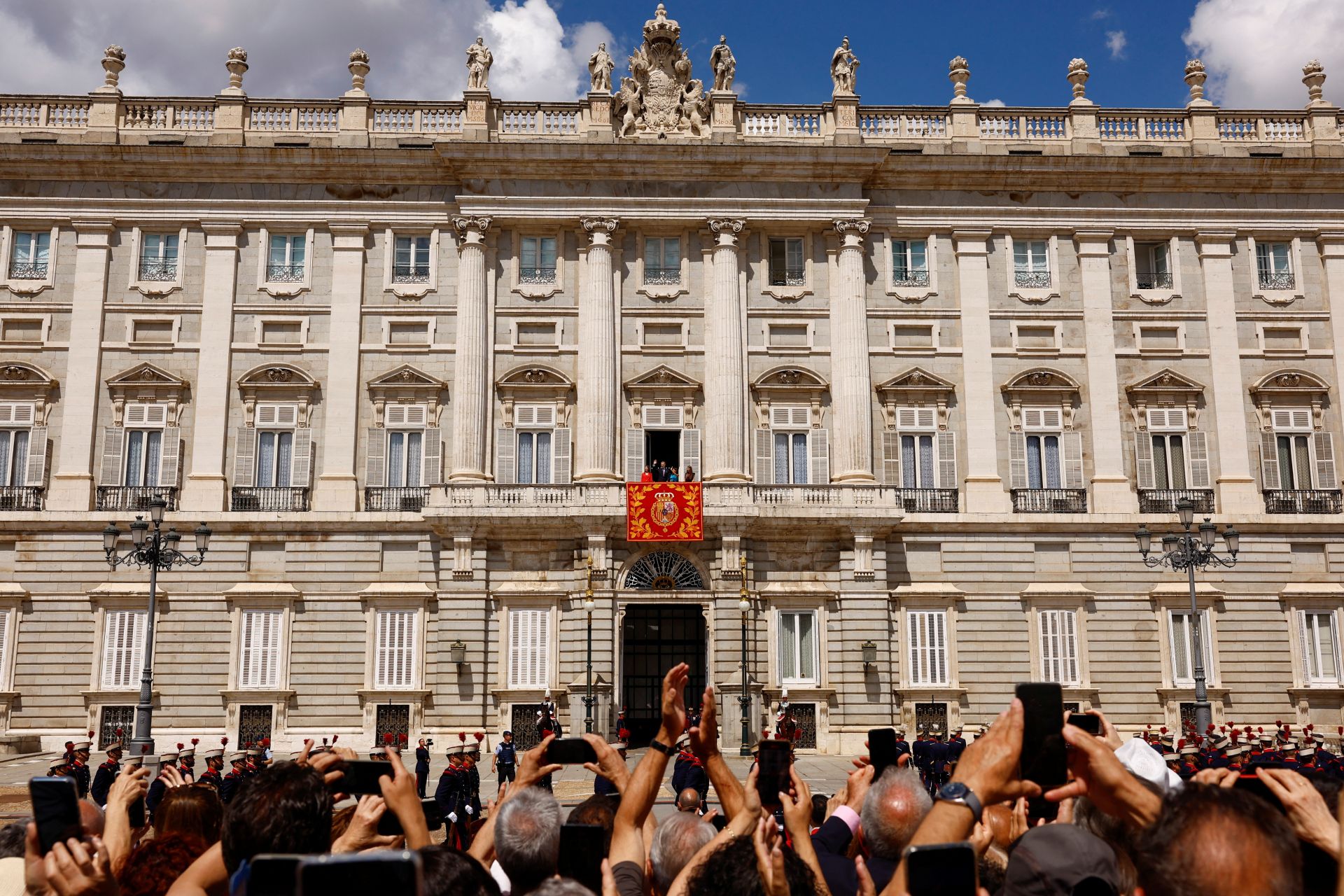 El rey de España Felipe, la reina Letizia y sus hijas, la princesa Leonor y la princesa Sofía, saludan desde un balcón después de asistir al relevo de la Guardia Real durante las conmemoraciones del décimo aniversario de la proclamación del rey de España Felipe VI