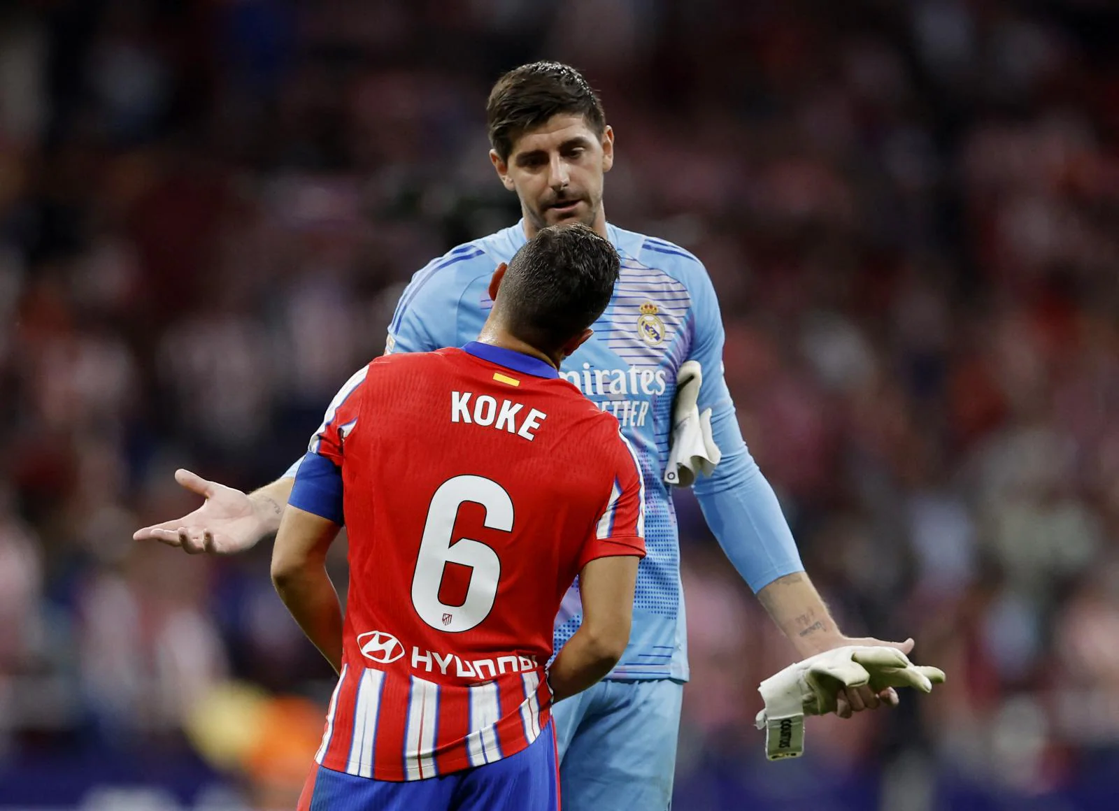 Koke, capitán del Atlético, dialoga con Courtois sobre los incidentes que se producían en el césped