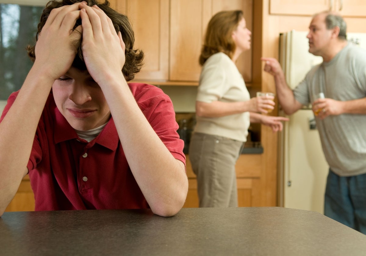 Un adolescente escucha abrumado la discusión entre sus padres divorciados.