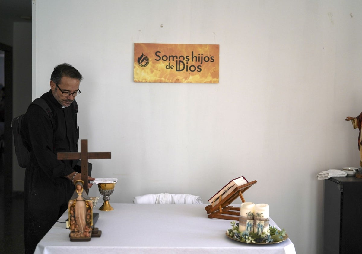 Salvador Romero, párroco de la iglesia de San Ramón de Paiporta, toca el corporal (que tapa el cáliz) que quedó a salvo de la DANA.