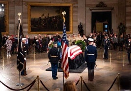 El público observa el ataúd cubierto con la bandera del expresidente Jimmy Carter en la Rotonda del Capitolio.