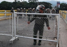 Un policía venezolano instala una valla para bloquear el Puente Simón Bolívar, que une a Colombia con el país bolivariano.