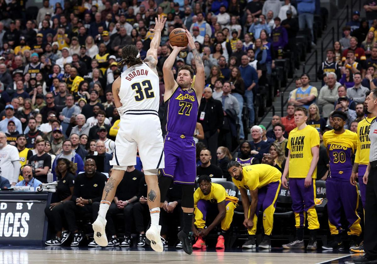 Luka Doncic, scoring a three-pointer against the Denver Nuggets