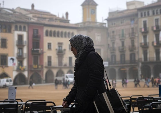 Una mujer inmigrante camina por la localidad catalana de Vic.