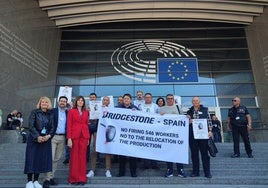La eurodiputada socialista Idoia Mendia y el vicesecretario del PSOE de Cantabria, Javier Incera, acompañan a los trabajadores de Bridgestone, que posan con una pancarta frente al Parlamento Europeo.