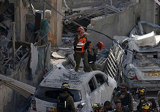 Rescatistas israelíes buscan entre los escombros en el lugar de un ataque con misiles iraníes esta madrugada en Bnei Brak.