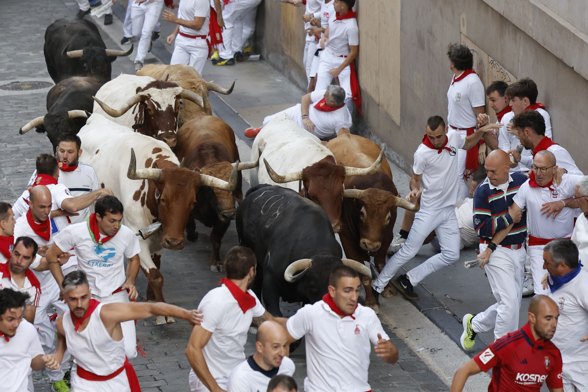 Un mozo evita a uno de los toros de la ganadería Jandilla en los primeros metros del encierro de este viernres.