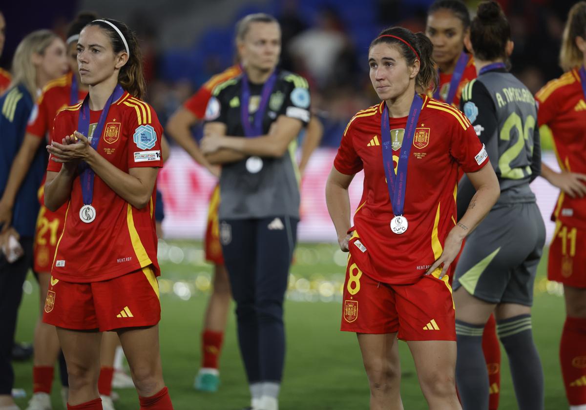 Mariona Caldentey y Aitana Bonmatí aplauden a las jugadoras inglesas que reciben el premio.