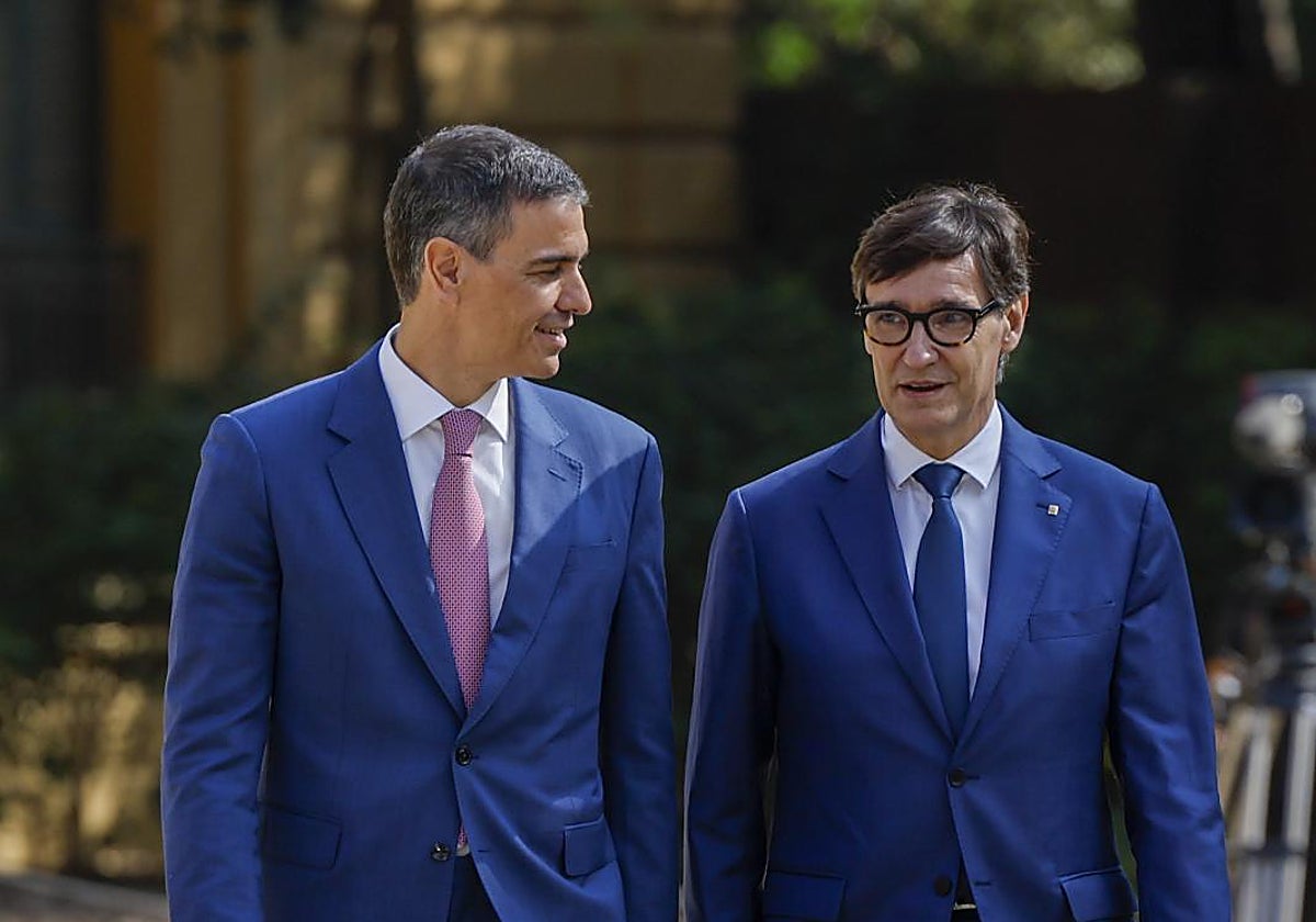 El jefe del Ejecutivo, Pedro Sánchez, conversa con el presidente de la Generalitat, Salvador Illa, mientras se dirigen a asistir a la Conferencia de Presidentes.