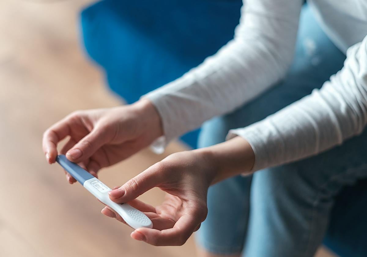 Una mujer contempla el resultado de un test de embarazo.