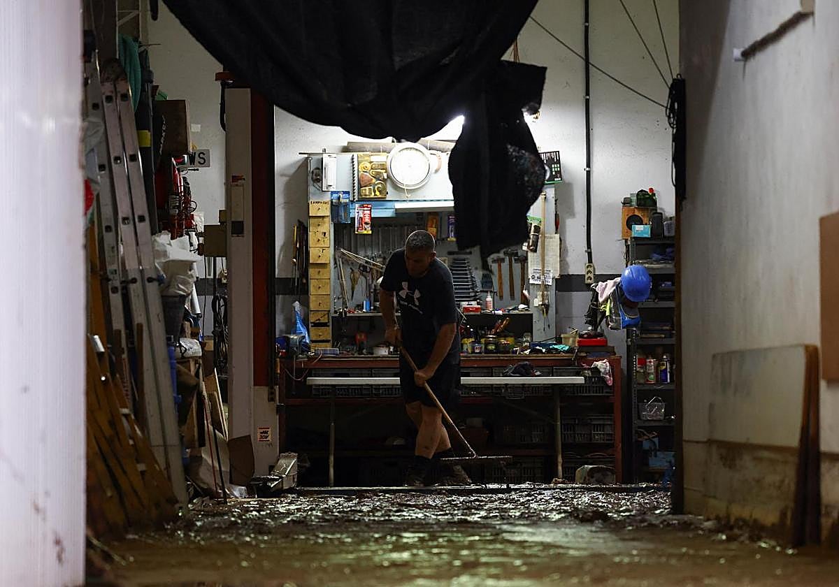 Una persona limpia los daños causados por la dana.