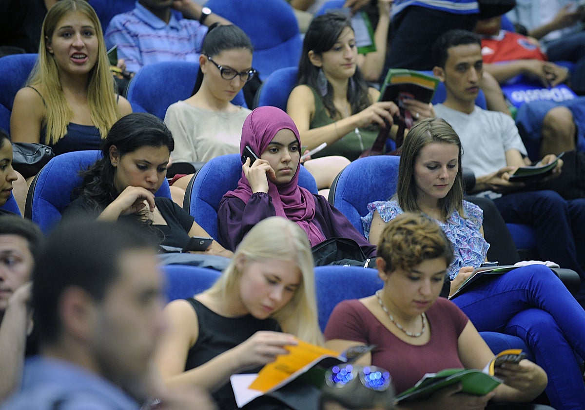 University students attend a presentation in an auditorium.