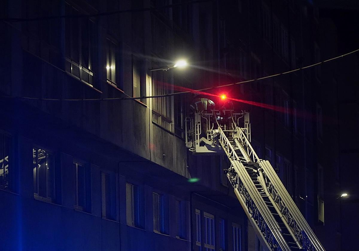 Firefighters attempt to access one of the apartments in the A Coruña building that caught fire on Thursday.