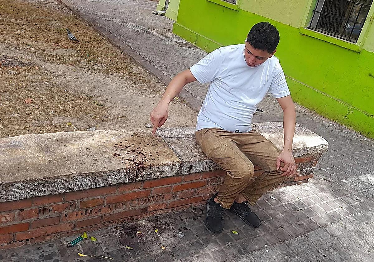 Un trabajador del local donde se inició la trifulca muestra los restos de sangre de la pelea en el exterior del kebab.