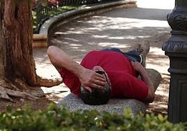 Una persona descansa en un banco por las altas temperaturas en Salamanca.