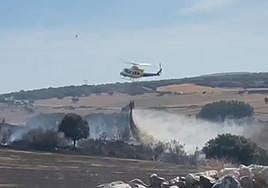 Un helicóptero vierte agua en la zona del fuego.