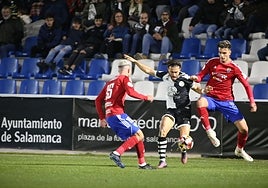 Mario Losada, trabado por dos jugadores del Teruel