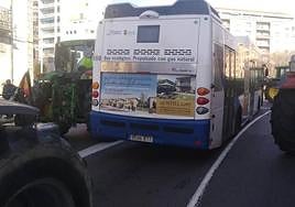 Uno de los buses atrapados por tractores en la plaza de España.