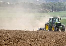 Imagen de archivo, un agricultor labrando la tierra con un tractor.