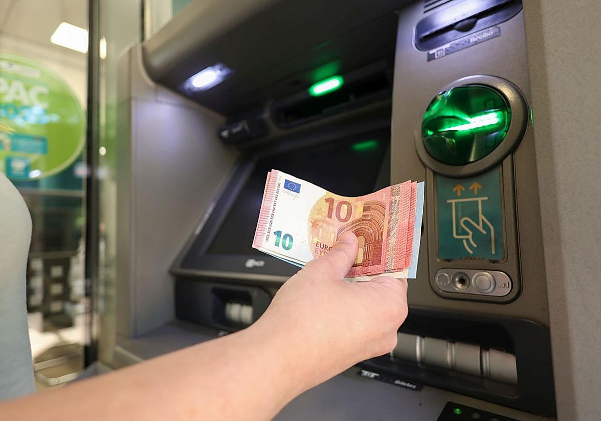 Un cliente saca dinero en un cajero automático.