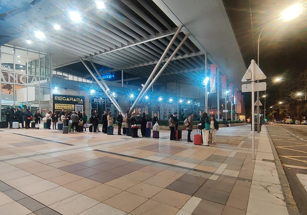 Cola de pasajeros esperando un taxi en la estación de trenes.