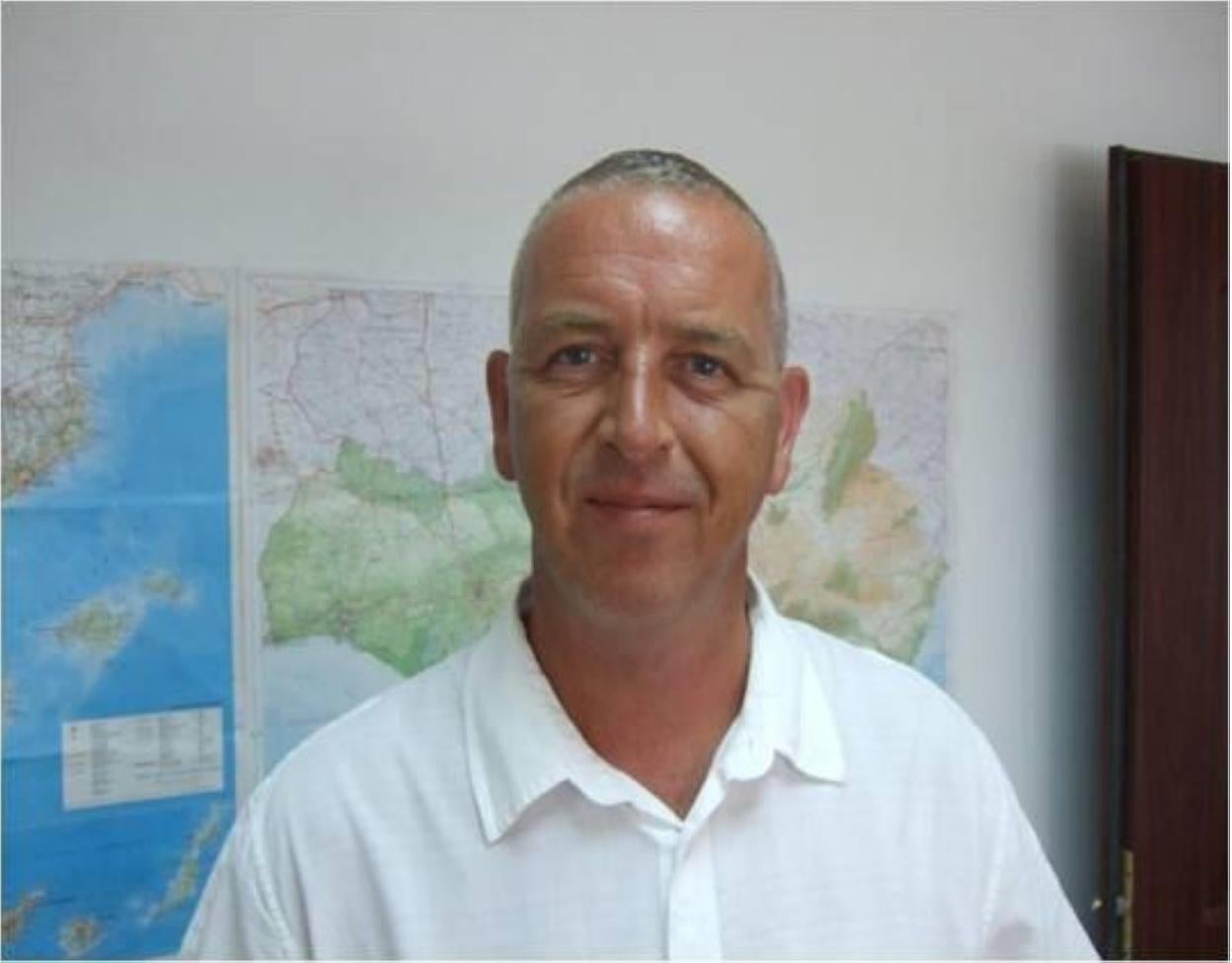 Steve Askham in front of a map of the world, which he knows well. 