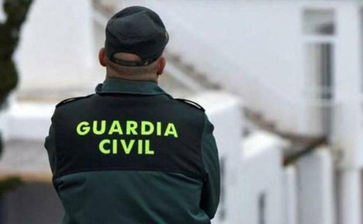 Guardia Civil officer outside the house where the animals were being kept in Motril 