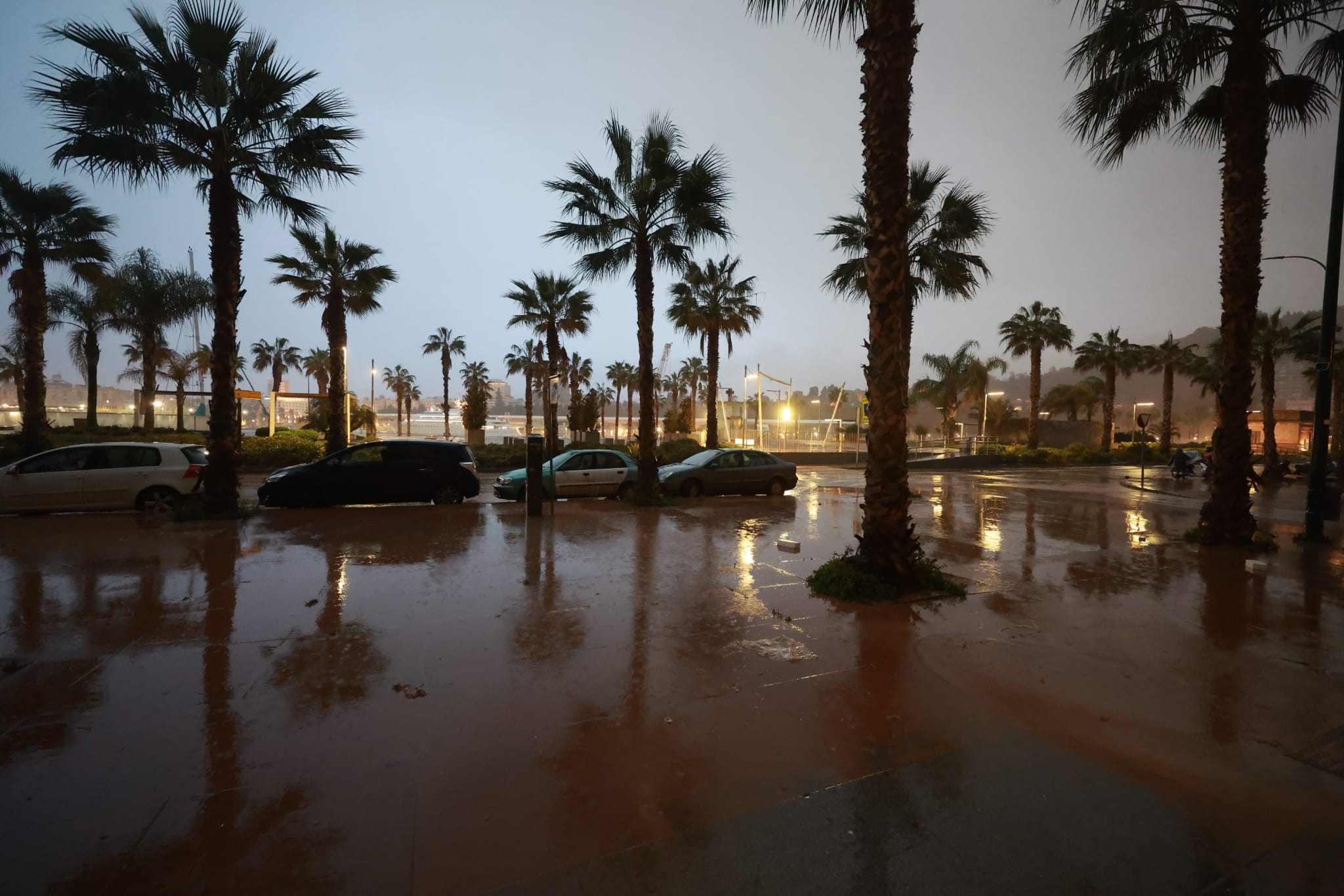 Malaga wakes to cars, buildings and streets covered in red mud
