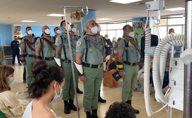 Soldiers pay a visit to the children's ward of a city hospital earlier this week. 