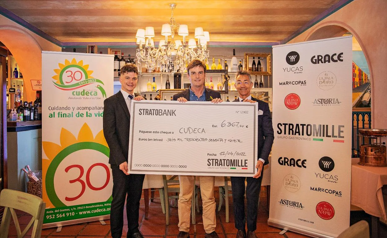 Representatives from the Stratomille Group present Cudeca with the cheque. 