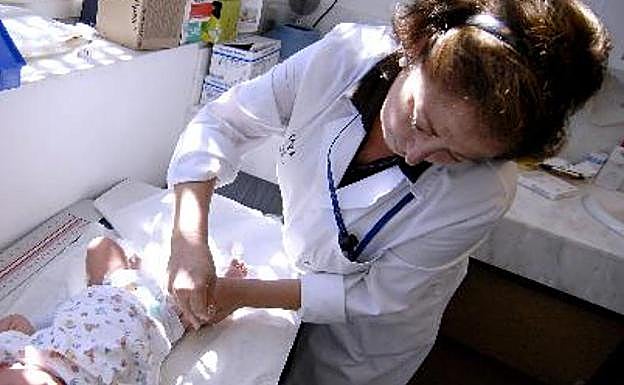 A pediatrician attends to a baby in a file image.