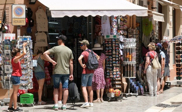 Tourists at a souvenir shop in Malaga. 