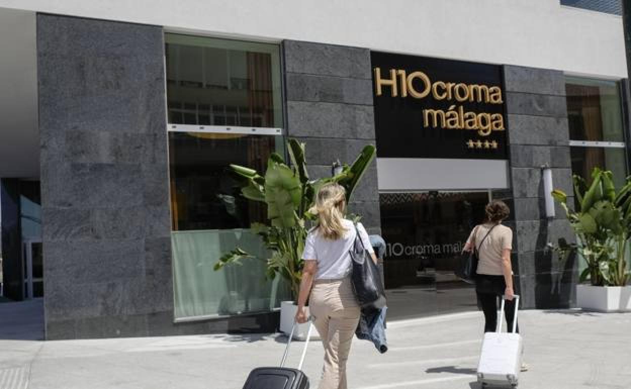 Tourists about to enter Malaga city's new hotel. 