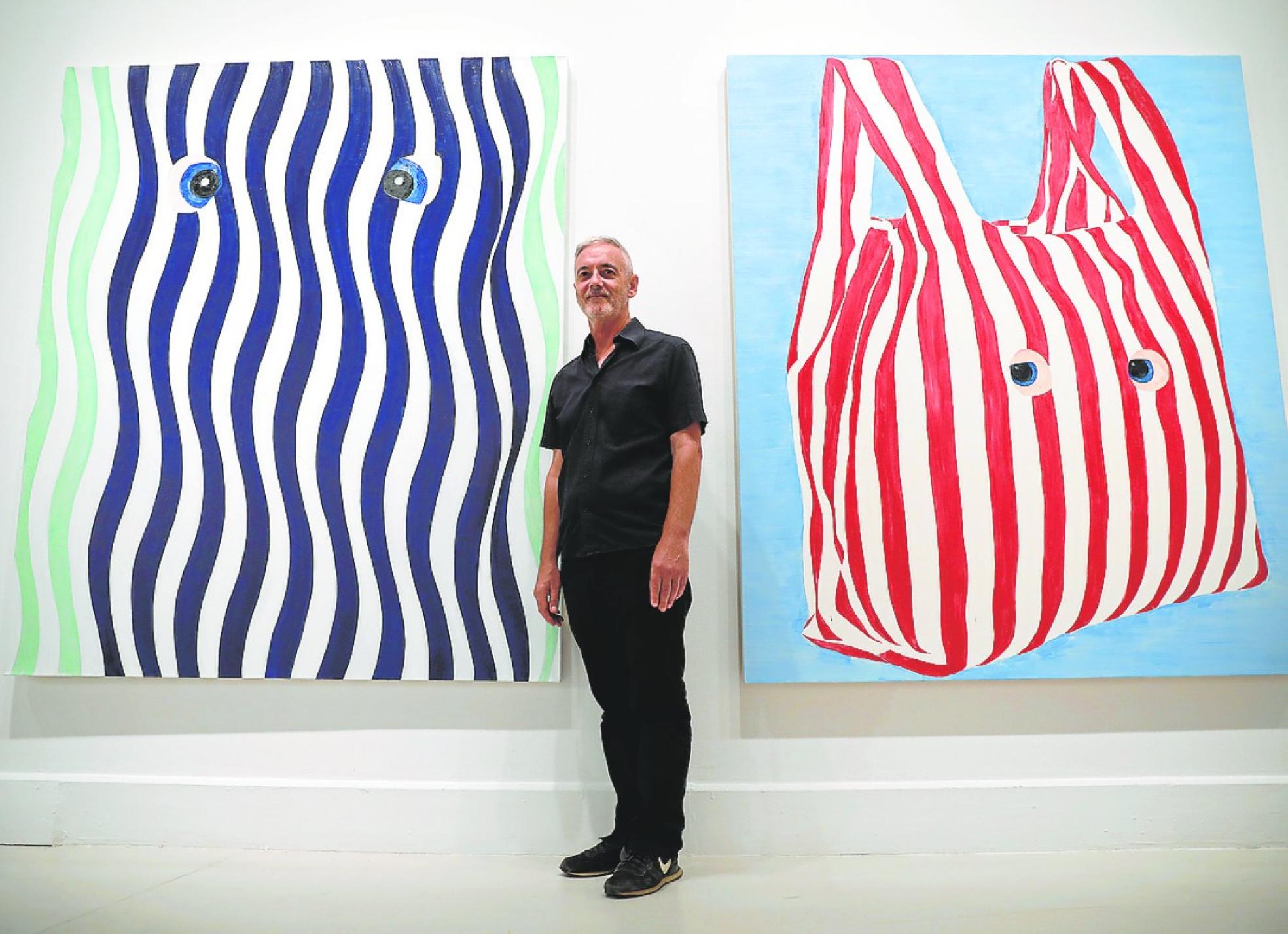 James Rielly in front of two of his works at the Contemporary Art Centre.